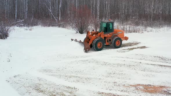 Piling up snow with a front end loader