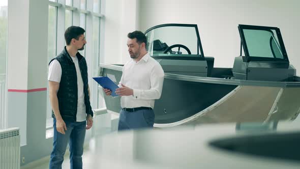 Male Seller Is Talking To a Client About a Boat