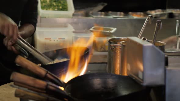 Chef is Stirring Vegetables in Wok Noodles Fire Flambe Asia Kitchen Chinesse Pan Pasta Seafood