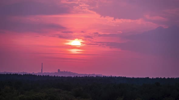 Sunset in the Purple Sky Above the Industrial City with Factory. Timelapse