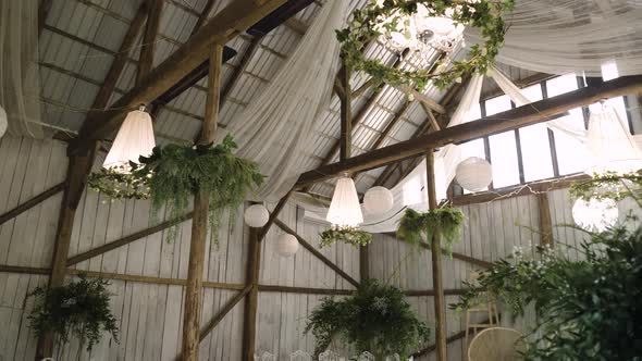 boho vintage wedding hall with stunning white lighters and green plants