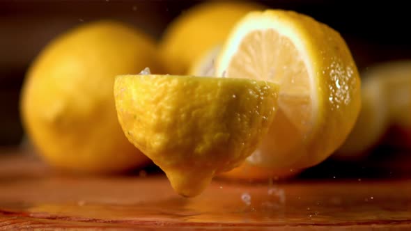 Super Slow Motion Fresh Lemon Falls on the Table and Breaks Into Two Halves