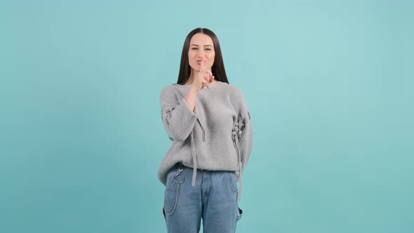 Girl Showing To Be Quiet with Finger Isolated on Red Background