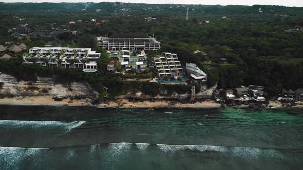 Beautiful Bingin beach with exotic cliffs houses and hotel located in Bali, Indonesia. This drone fo