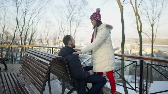 Happy Romantic Couple Haveing a Date on the Bench at Sunny Winter Day