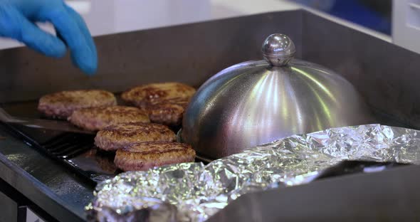 Meat Beef Patty is Cooked in a Hot Frying Pan