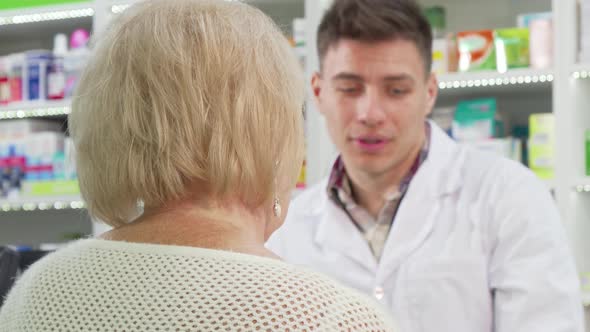 Rear View Shot of a Senior Woman Smiling To the Camera After Buying Medicine