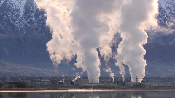 View of natural gas power plant blowing smoke into the air