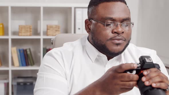 Workplace of freelance worker at home office. Young African-American man.