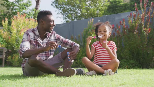 African american father and daughter playing outside