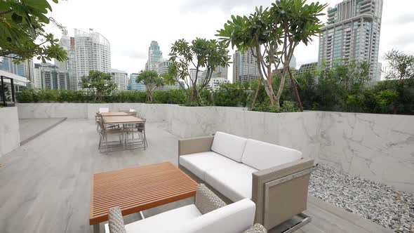 Cosy Area Furnished with ARmchairs and Sofas on the Roof Top Garden