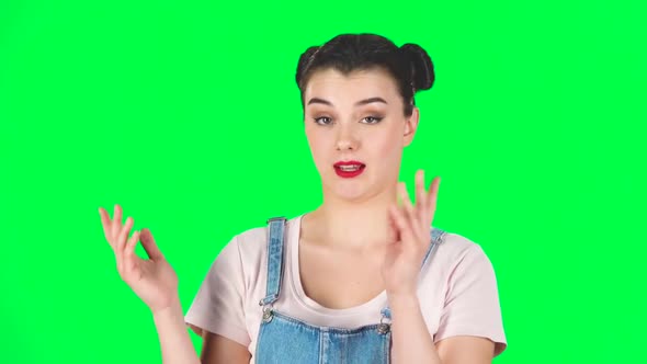 Girl with Two Hair-buns Claps Her Hands Indifferently Then Yawns on Green Screen. Slow Motion