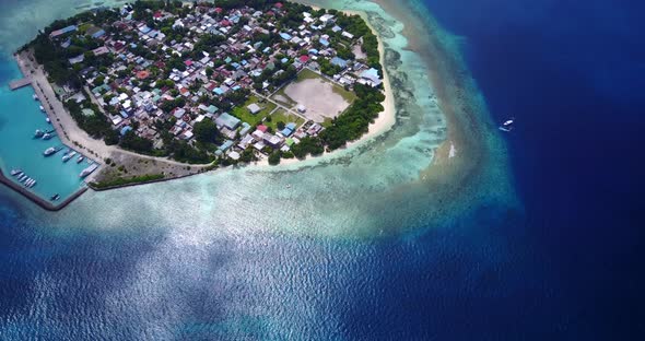 Luxury fly over island view of a white paradise beach and aqua blue water background in 4K