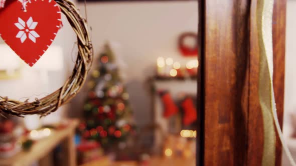 Christmas grapevine wreath with ribbon hanging on window