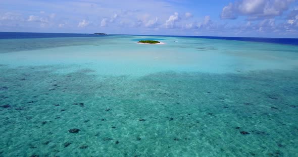 Daytime fly over abstract shot of a summer white paradise sand beach and aqua turquoise water backgr