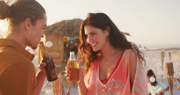 Caucasian friends enjoying a party on the beach