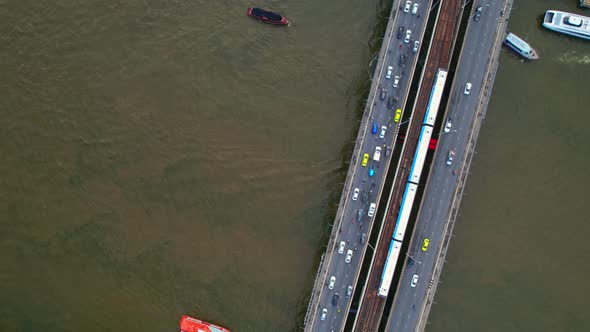 Aerial view flight over moving sky train on a bridge over the Chao Phraya River