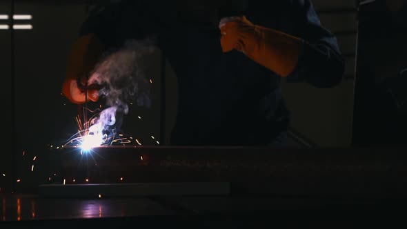 Metal Welder Working with Arc Welding Machine