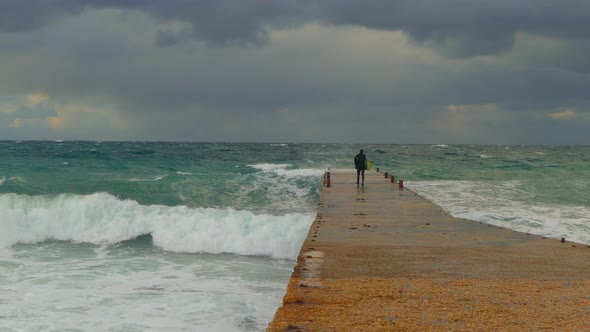 A Scuba Diver Goes to the Pier During a Storm