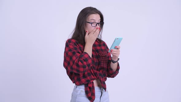 Young Beautiful Hipster Woman Using Phone and Looking Shocked