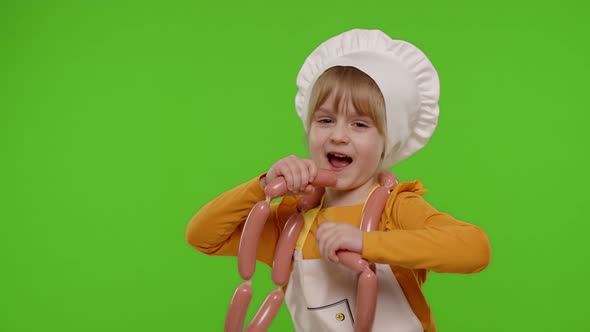 Teen Child Girl Dressed As Cook Chef in Apron Dancing with Sausages Fooling Around on Chroma Key