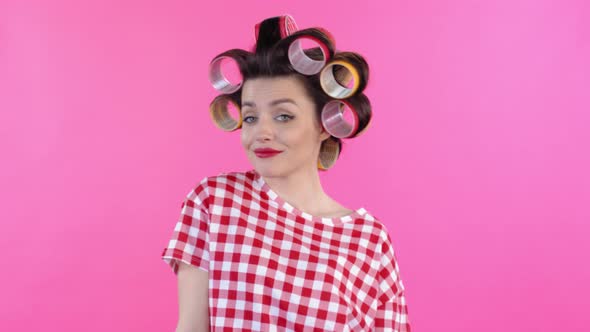 Woman with Hair Rollers Dancing for Camera