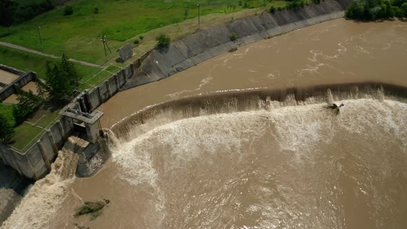 Aerial Drone View. River Water Move Down From with a Water Filled Dam After Heavy Floods and Rains