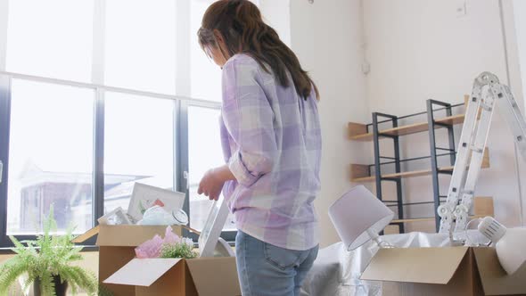 Asian Woman Packing Box and Moving to New Home