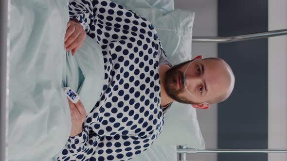Vertical Video Potrait of Sick Man Resting in Bed Waiting for Respiratory Treatment