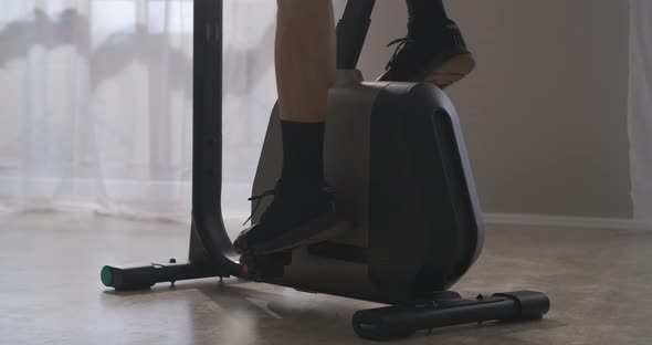 Bicycle Training at Home Man Is Spinning Pedals Closeup of Feet Fitness and Wellness Endurance and