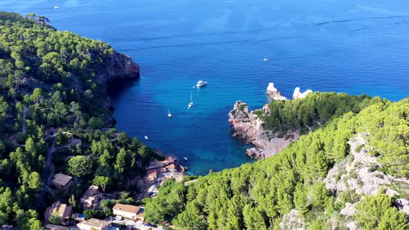 Marmassen Cove near Port Andratx in Mallorca Spain with rustic homes by the beach, Aerial pan right