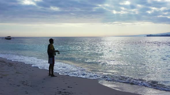 Single guy angler on relaxing bay beach lifestyle by blue green sea and white sandy background of Lo