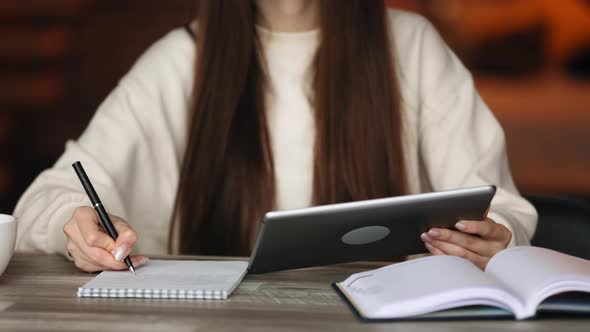 A Woman is Working on a Tablet