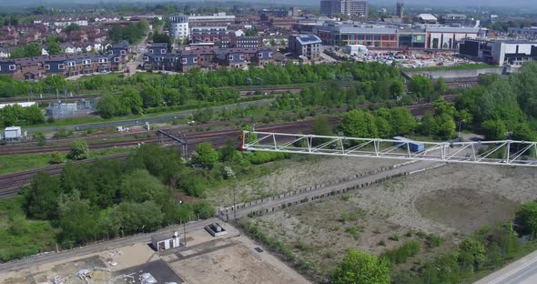 Aerial view of Ashford town, Kent, UK with a pan reveal from behind a crane.