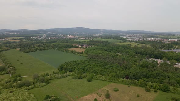 Approaching flight towards an abandoned military airfield within forests and fields in Eschborn, Ger