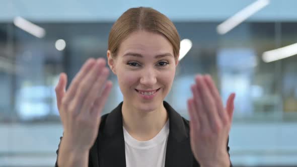 Portrait of Businesswoman Pointing at the Camera and Inviting