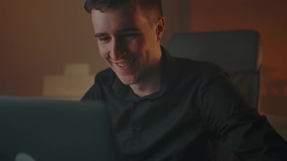 Caucasian Man Smiles Cutely While Talking in Online Conference