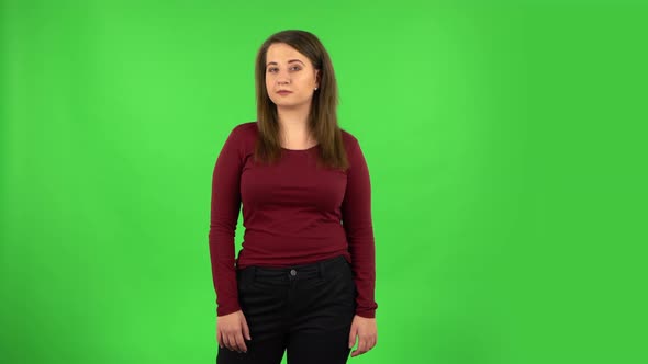 Pretty Girl Coquettishly Smiling While Looking at Camera. Green Screen