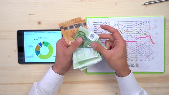 Accountant counting euro notes