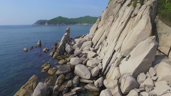 Drone View of the Beautiful Sea Rocky Coast with Clear Blue Water