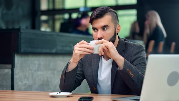 Focused Handsome Business Male Enjoying Coffee Break in Cafe During Working Using Laptop Pc