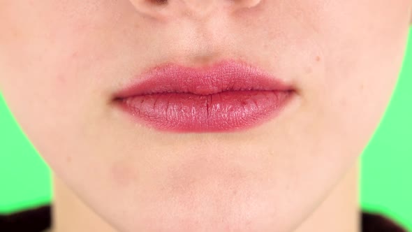 Young Woman with a Pink Lips Smiling Revealing Teeth. Close Up