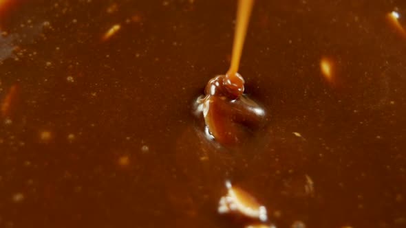 Caramel being mixed in melted chocolate