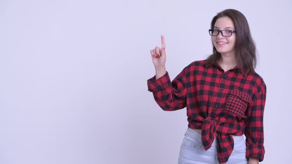 Happy Young Beautiful Hipster Woman Thinking and Pointing Up