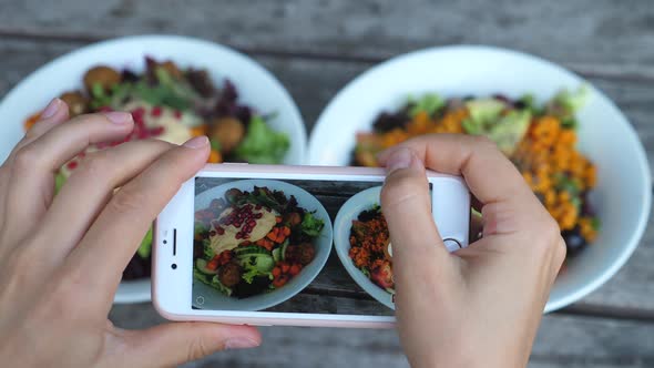 Close Up Of Hands Taking Photos Of Food In Cafe, Focus On Salad Bowls In Smartphone Screen