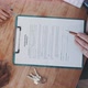 Top shot of rental contract keys and hands of a couple and agent on wooden table top - VideoHive Item for Sale