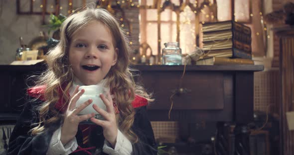 Adorable Little Student of the Magic School is Holding a Steaming Jar
