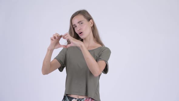 Happy Young Beautiful Woman with Hand Heart Gesture