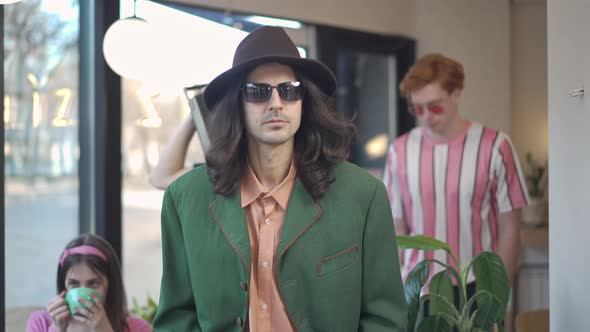 Three Confident Retro Dandy Men with Vintage Tape Recorder on Shoulder Leaving Vintage Coffee Shop