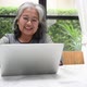 Asian elderly woman is communicating with another person, through online channels - VideoHive Item for Sale